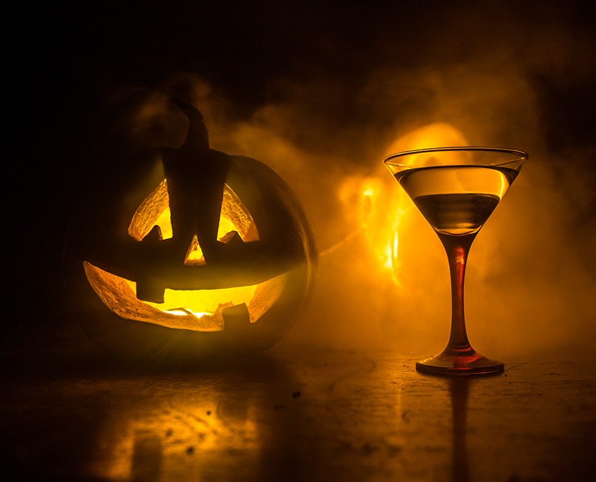 A Jack-o-lantern parties with a cocktail