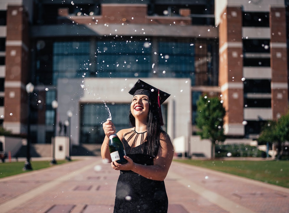 Girl Celebrates Graduation by Popping Champagne